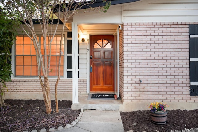 entrance to property with brick siding