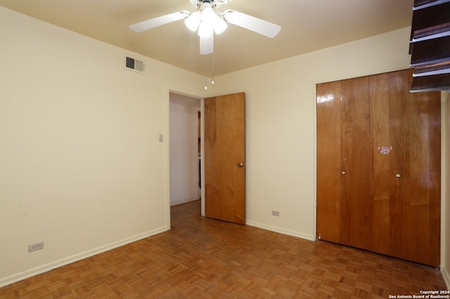 unfurnished bedroom with ceiling fan, a closet, visible vents, and baseboards