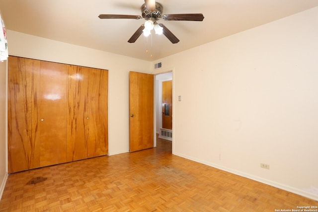 unfurnished bedroom with a closet, visible vents, and baseboards