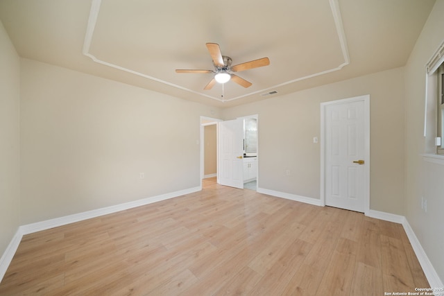 unfurnished bedroom featuring a ceiling fan, light wood-type flooring, and baseboards