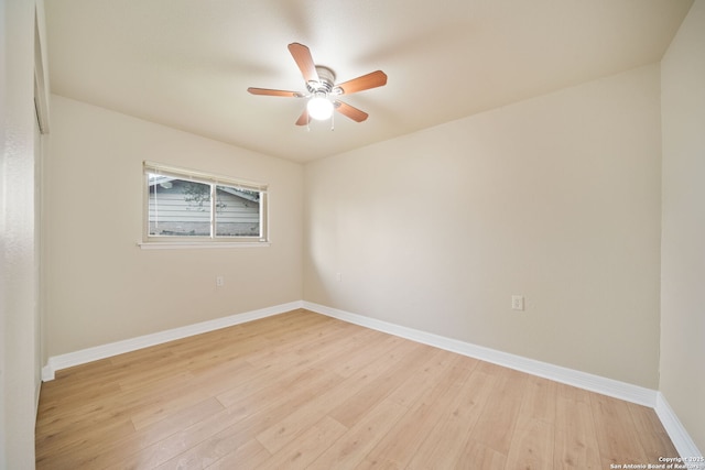 empty room with light wood-style floors, a ceiling fan, and baseboards