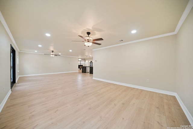 unfurnished living room with crown molding, recessed lighting, baseboards, and light wood-style floors