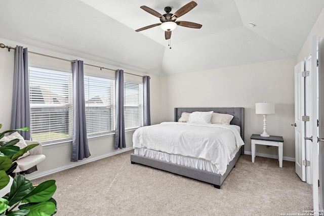 carpeted bedroom featuring a ceiling fan, lofted ceiling, and baseboards