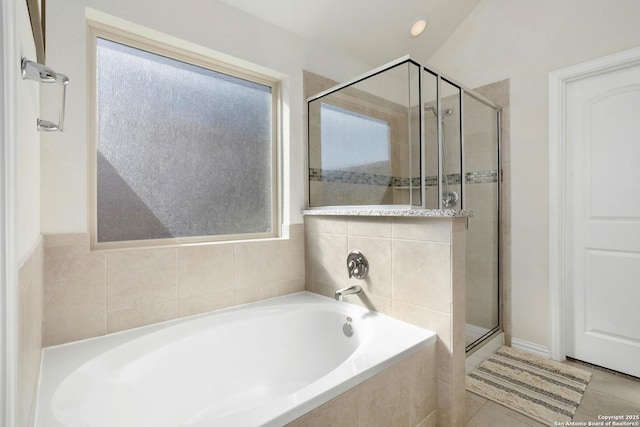 full bath with a stall shower, tile patterned flooring, and a garden tub