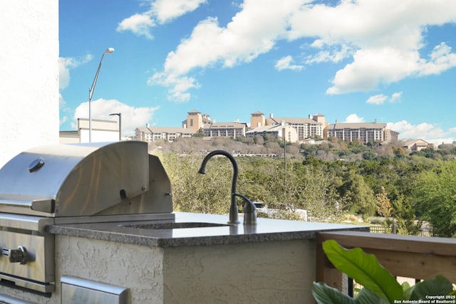 view of patio / terrace featuring grilling area and an outdoor kitchen