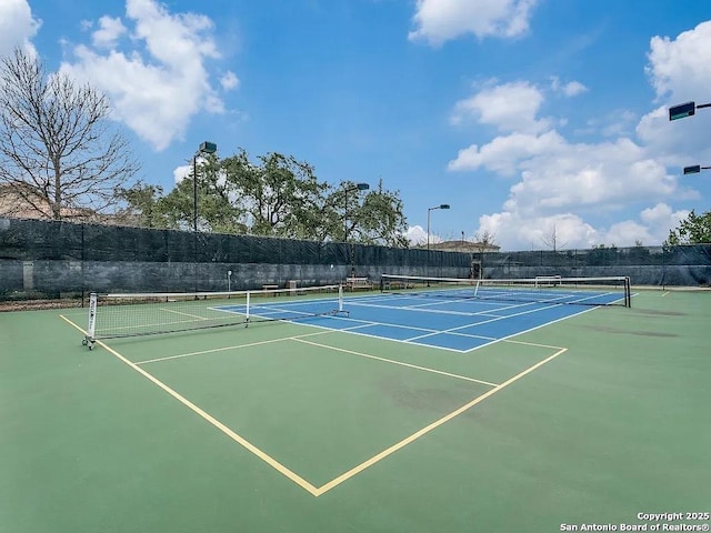 view of sport court featuring fence