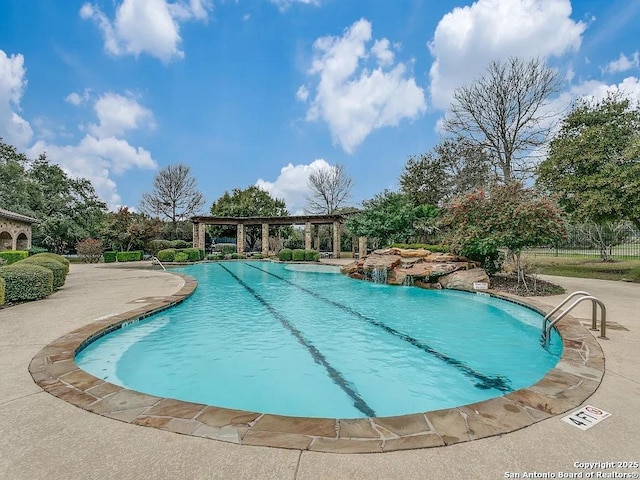 pool featuring a pergola and a patio