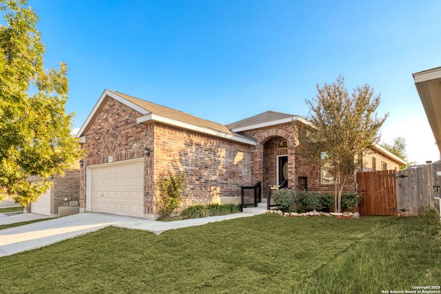 view of front of house with a garage, a front yard, concrete driveway, and brick siding