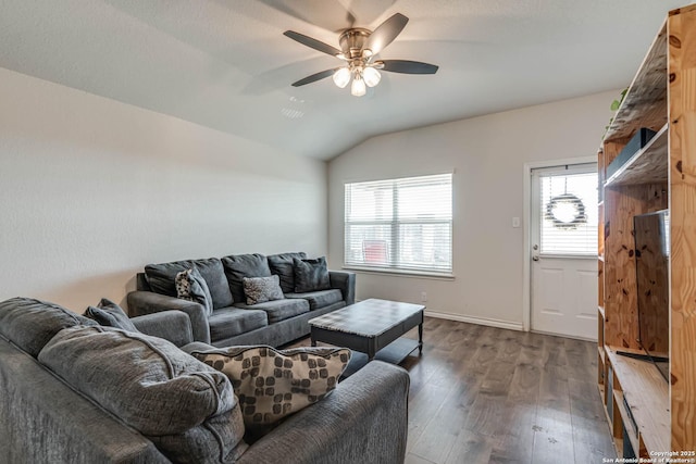 living area featuring vaulted ceiling, baseboards, dark wood finished floors, and a ceiling fan