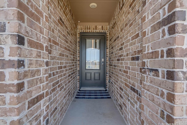 property entrance with brick siding