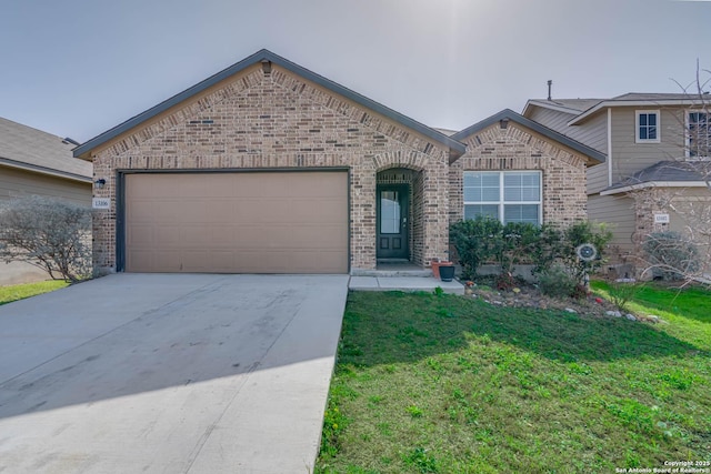 view of front facade featuring a front yard, brick siding, driveway, and an attached garage