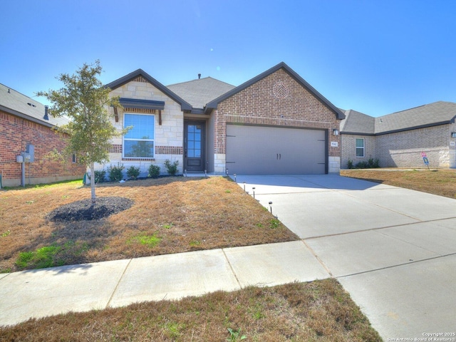 view of front of home with a garage, driveway, stone siding, a front lawn, and brick siding