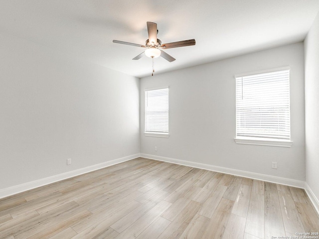 empty room featuring light wood-style floors, baseboards, and a ceiling fan