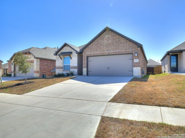 view of front facade featuring brick siding, concrete driveway, an attached garage, a front yard, and stone siding