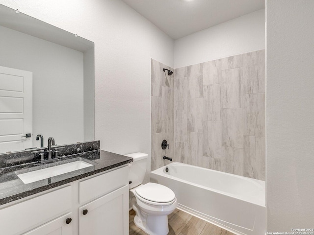 full bathroom featuring shower / bathtub combination, vanity, wood finished floors, and toilet