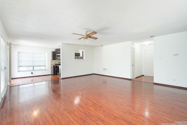 unfurnished living room with visible vents, a ceiling fan, a textured ceiling, and dark wood-style floors