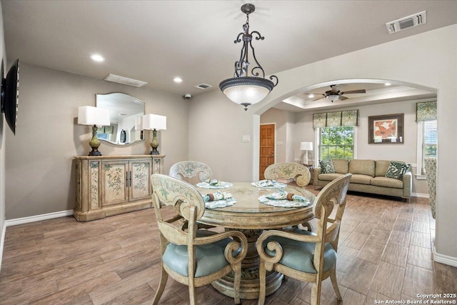 6822 Moss Oak, San Antonio, TX 78229 - dining room with arched walkways, a ceiling fan, wood finished floors, and recessed lighting