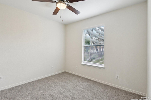 carpeted empty room featuring ceiling fan and baseboards