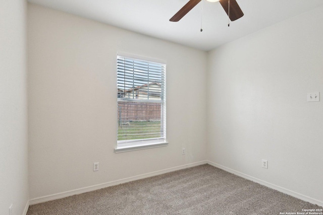 carpeted empty room with ceiling fan and baseboards