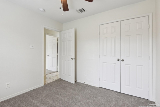 unfurnished bedroom with carpet floors, a closet, visible vents, a ceiling fan, and baseboards