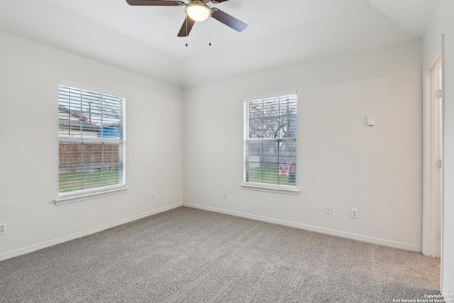 empty room featuring carpet floors, baseboards, and a ceiling fan