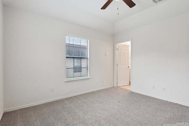 spare room with light carpet, ceiling fan, and baseboards