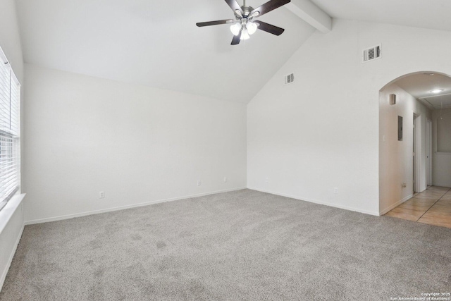 interior space featuring attic access, arched walkways, visible vents, and beamed ceiling