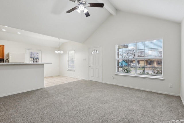 unfurnished living room with light carpet, baseboards, beamed ceiling, high vaulted ceiling, and ceiling fan with notable chandelier