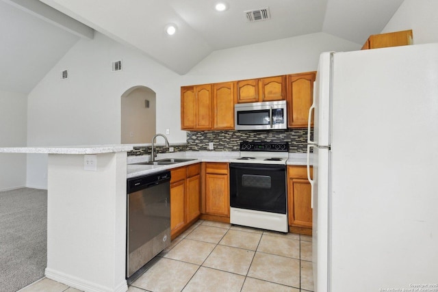 kitchen featuring a sink, visible vents, vaulted ceiling, light countertops, and appliances with stainless steel finishes