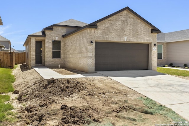 9538 Reinhartz Way, San Antonio, TX 78221 - view of front of house with a garage, brick siding, fence, and driveway