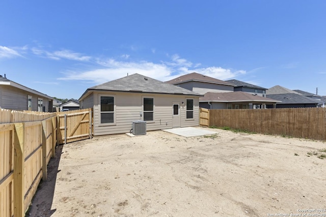 9538 Reinhartz Way, San Antonio, TX 78221 - back of property with a fenced backyard, a patio area, and central AC