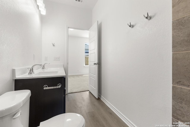 9538 Reinhartz Way, San Antonio, TX 78221 - bathroom with vanity, toilet, and wood finished floors