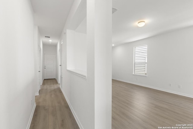 9538 Reinhartz Way, San Antonio, TX 78221 - hall with wood finished floors, baseboards, and recessed lighting