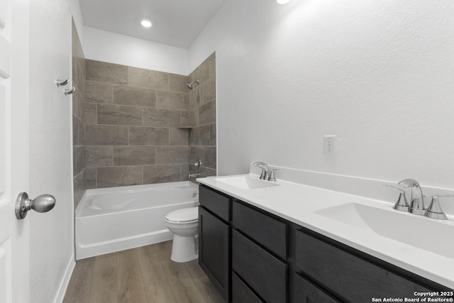 9538 Reinhartz Way, San Antonio, TX 78221 - bathroom featuring wood finished floors, toilet, bathtub / shower combination, and double vanity