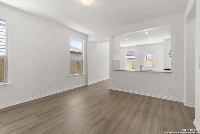9538 Reinhartz Way, San Antonio, TX 78221 - unfurnished living room with wood finished floors, baseboards, and recessed lighting