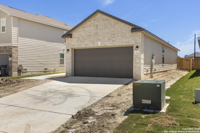 9538 Reinhartz Way, San Antonio, TX 78221 - view of side of home featuring a garage, driveway, brick siding, and fence