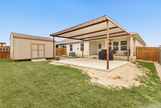 back of house with a patio area, a fenced backyard, and an outdoor structure