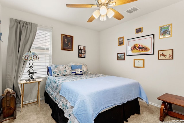 bedroom with visible vents, ceiling fan, light carpet, and baseboards