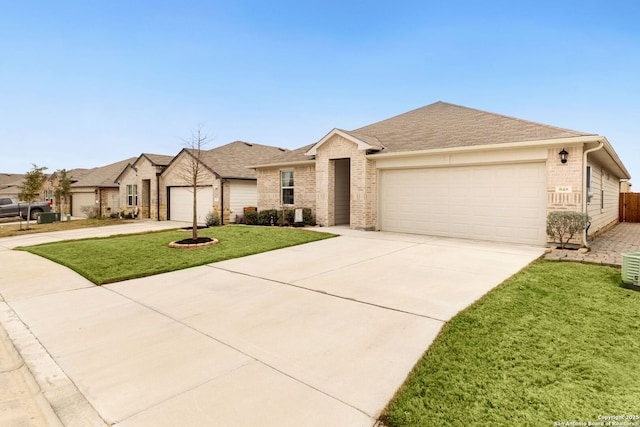 view of front of property featuring brick siding, roof with shingles, a garage, driveway, and a front lawn