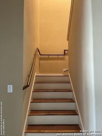 staircase featuring baseboards