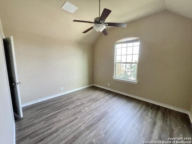 unfurnished room featuring vaulted ceiling, ceiling fan, dark wood-style flooring, and baseboards