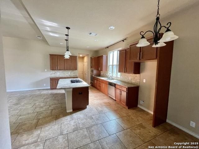 kitchen featuring a sink, tasteful backsplash, brown cabinets, and dishwasher