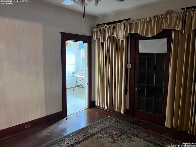 spare room featuring wood finished floors and crown molding