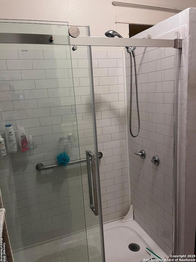 bathroom featuring a shower stall