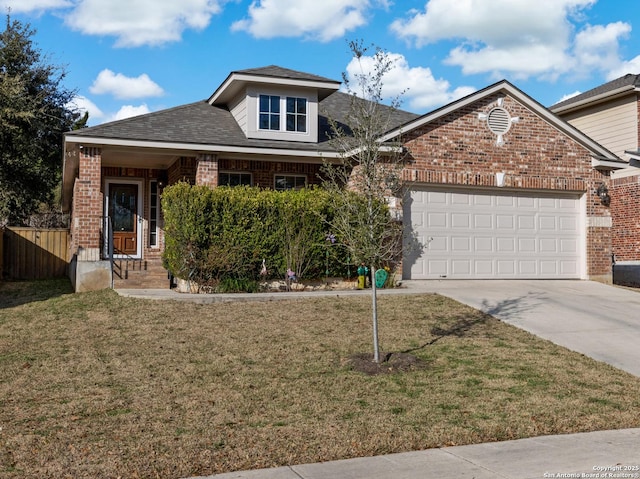 view of front facade featuring brick siding, an attached garage, a front yard, fence, and driveway