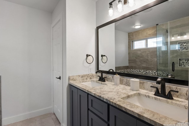 full bath with tile patterned flooring, a shower stall, baseboards, and a sink