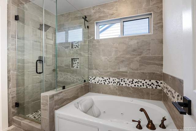 bathroom with a whirlpool tub and a stall shower