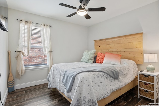 bedroom featuring dark wood-style floors, ceiling fan, and baseboards