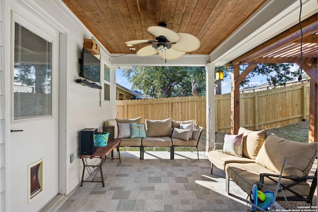 sunroom / solarium with a wealth of natural light, wood ceiling, and ceiling fan