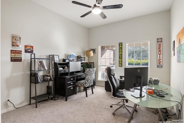 carpeted office space featuring a ceiling fan